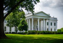 Federal Judge Blocks WH from Revoking 3 News Outlets Credentials The White House viewed through surrounding lush trees and foliage.