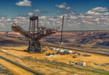 Zimbabwe Gold Deliveries Total 35.88 Tonnes Through September Overhead shot of excavators and trucks working in a sprawling open-pit mine with overcast skies.